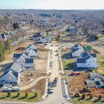 An aerial view of a residential neighborhood with lots of houses and trees.