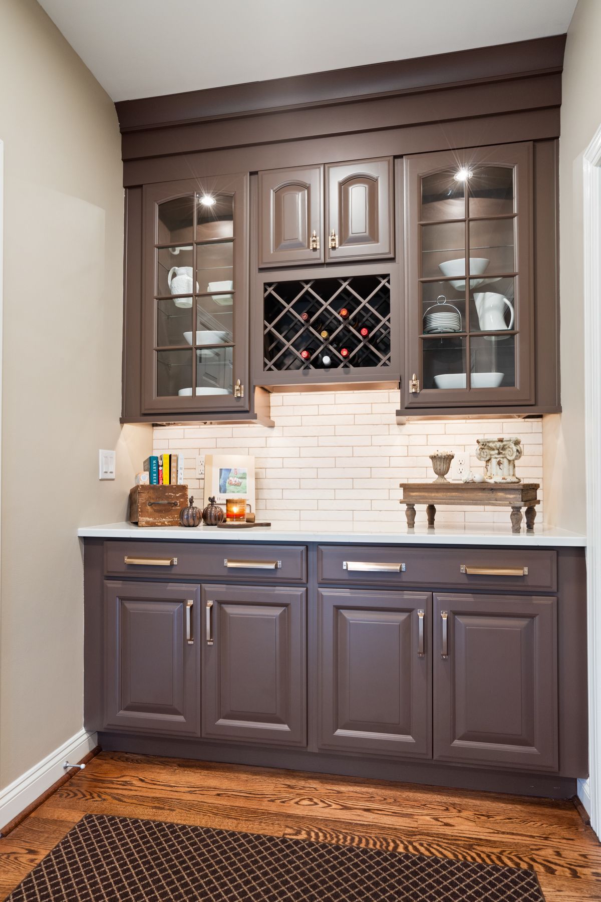 A kitchen with brown cabinets and a wine rack
