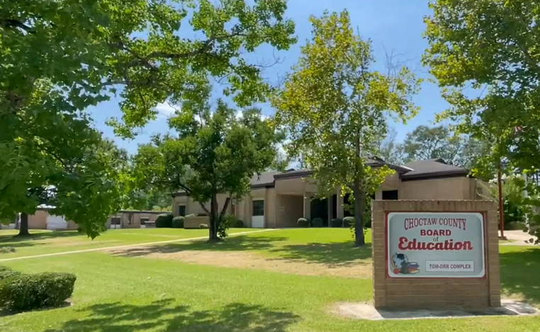 a sign in front of a building that says education