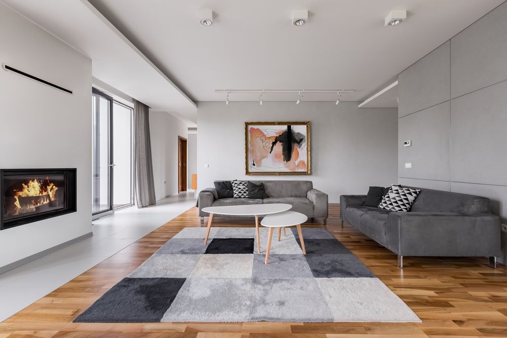 A Living Room With a Fireplace, Couch, Table and Rug — A&J Painting In Gungahlin, NT