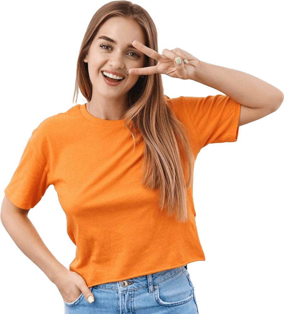 A woman in an orange t-shirt and blue jeans is giving a peace sign. - systane eye drops