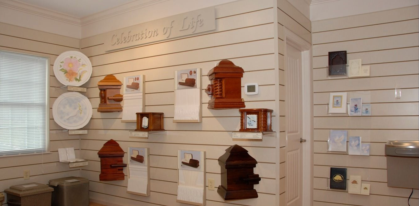Display wall of decorative wooden clocks and plaques on white slatwall shelves