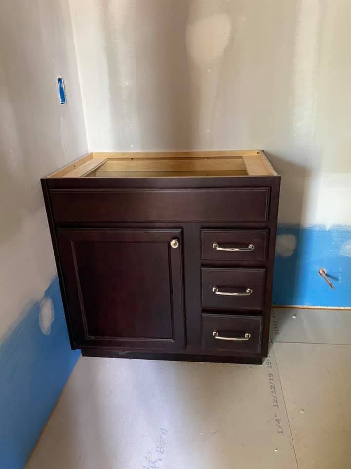 A bathroom vanity is being built in a bathroom.