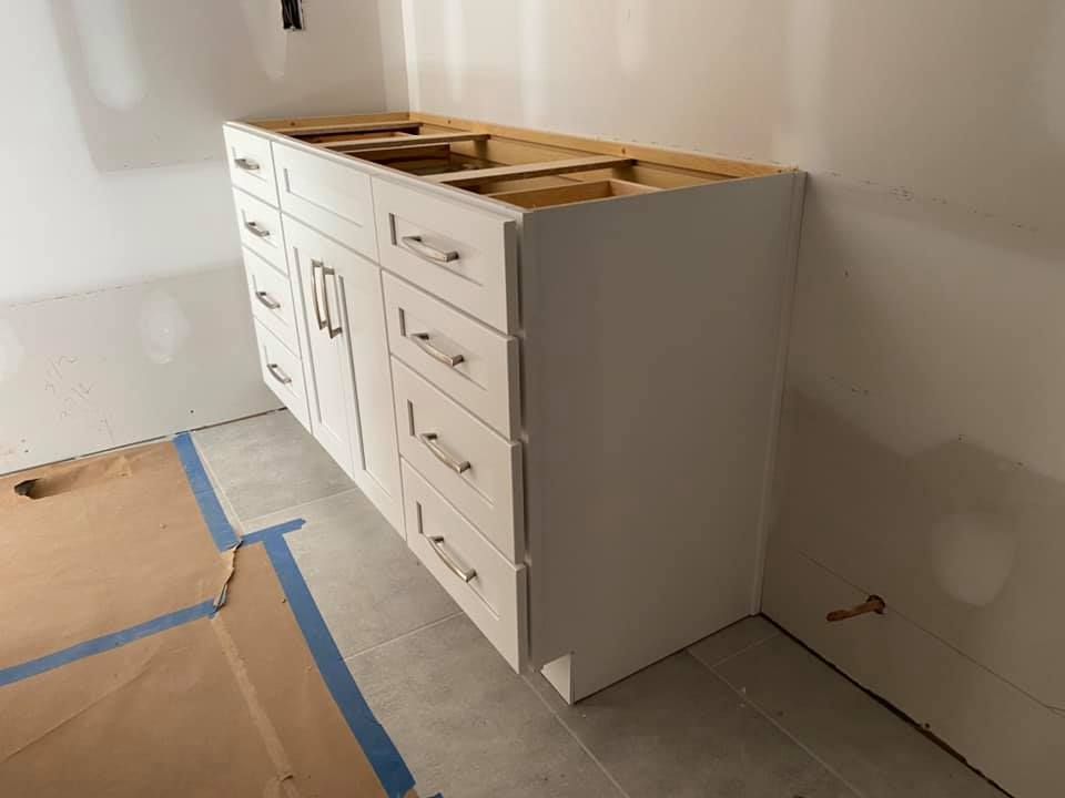 A bathroom vanity is being built in a room.