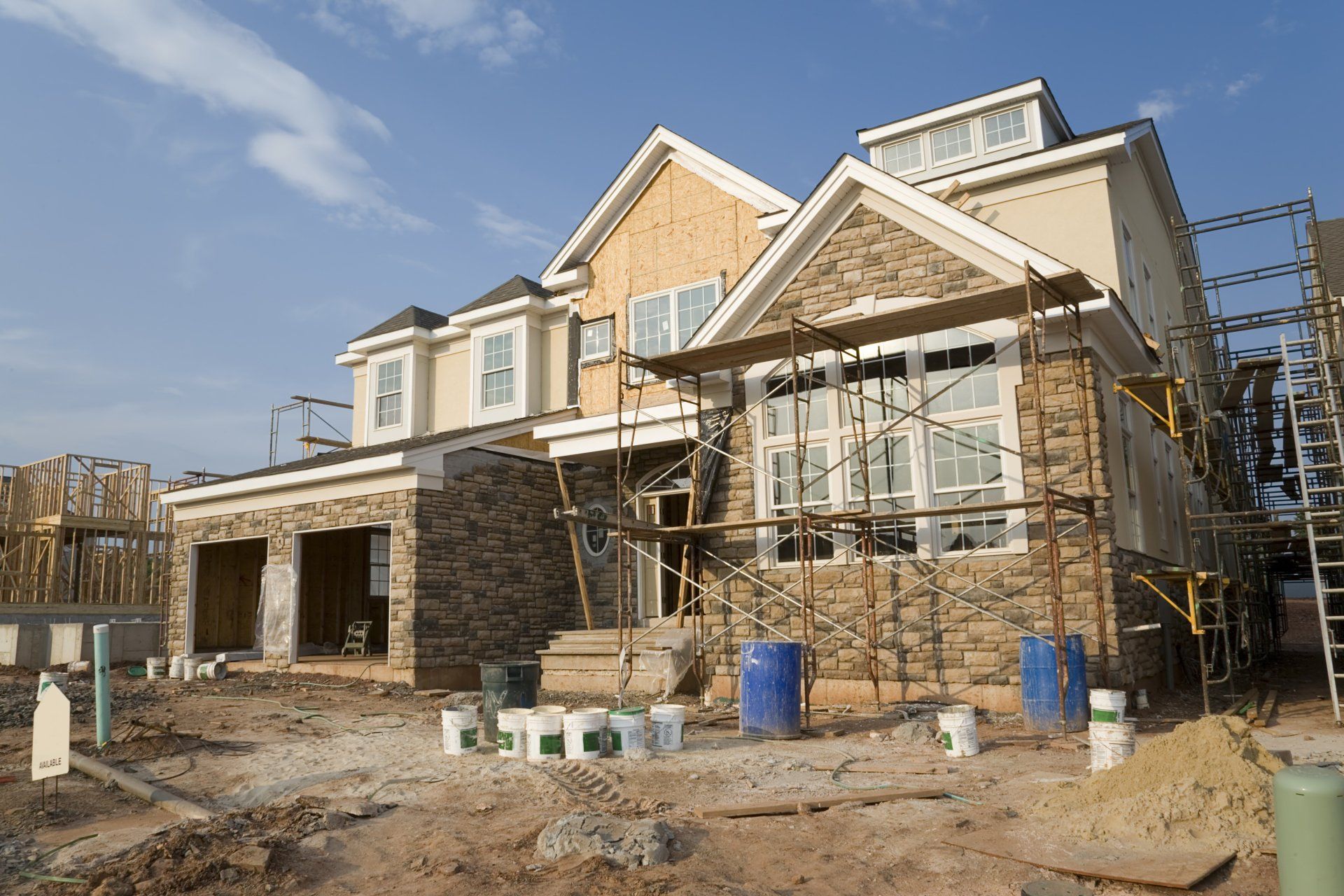 A large house is being built with scaffolding around it