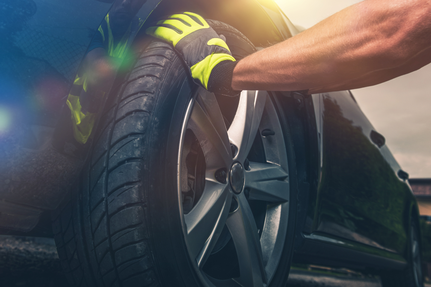 A person is changing a tire on a car.