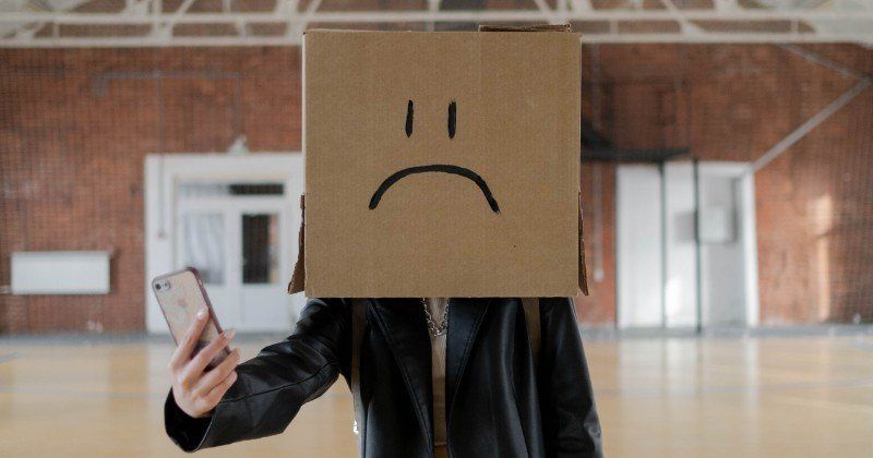 Masked man taking selfie