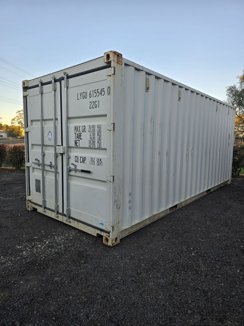 A Large White Shipping Container is Parked in a Gravel Lot — Toowoomba Container Hire & Sales in Wilsonton, QLD