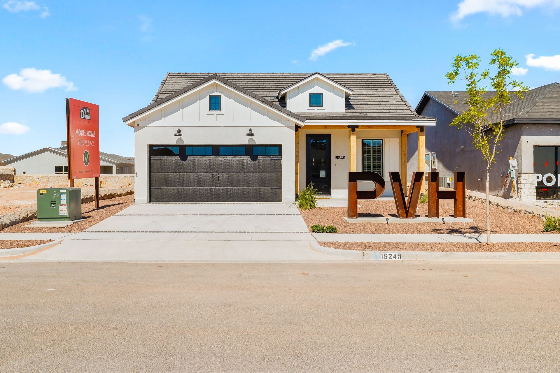 Modern white house with dark garage door, brown accents, and 
