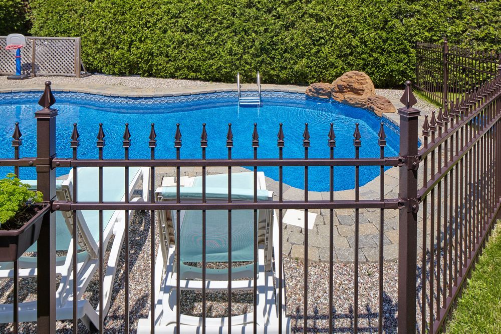 Metal Fence Borders a Backyard Swimming Pool — A Betta Fence 'N' Yard In Port Macquarie, NSW