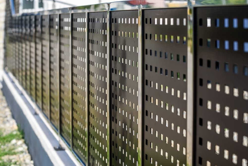 A Modern Fence With Dark, Square-perforated Metal Panels Held — A Betta Fence 'N' Yard In Port Macquarie, NSW