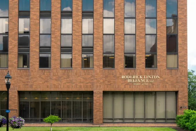 A brick building with the name roderick linton reliance on it