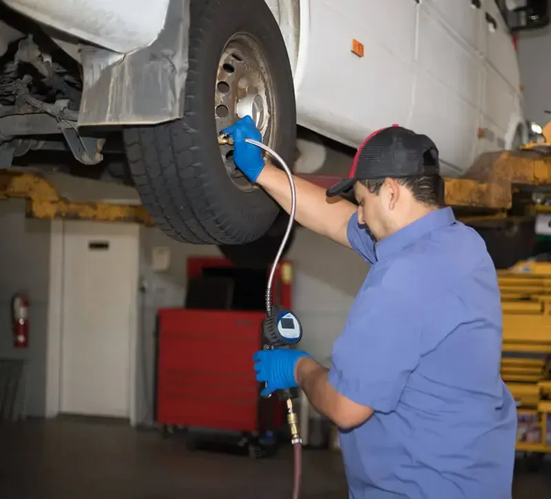 Mechanic Checking Tire Pressure in Raleigh, NC - MJ Brothers Auto & Truck Repair