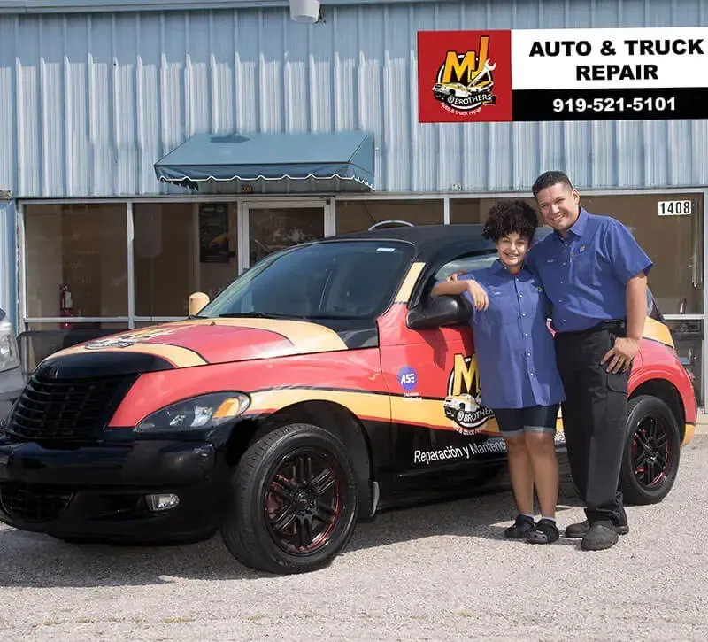 Mechanic With Kid in Front of Our Auto Repair Shop in Raleigh, NC - MJ Brothers Auto & Truck Repair