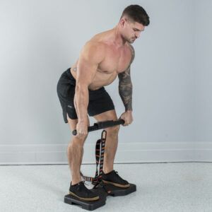 A shirtless man is lifting a barbell in a gym.