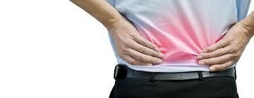 A man is holding his back in pain.