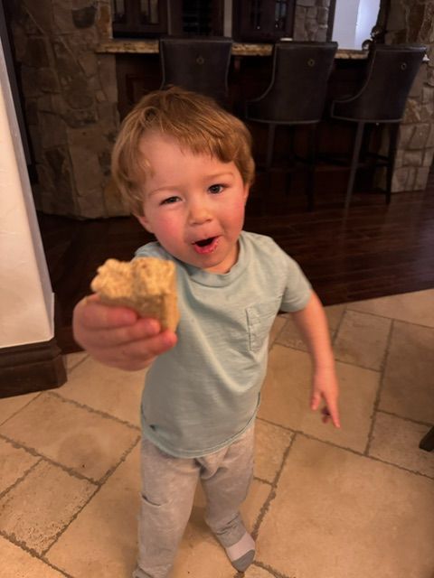 Child smiling while holding Power Pucks honey bar