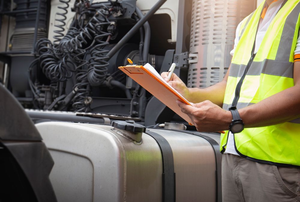 Person in Safety Vest Inspecting a Truck — Envy Automotive in Woongarrah, NSW