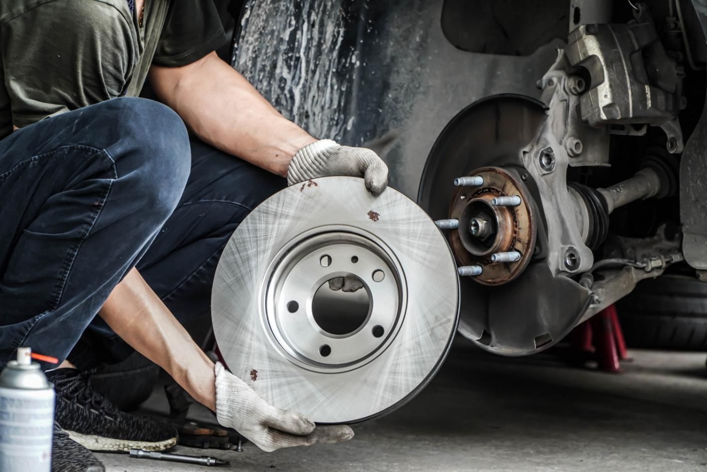 A Man Is Fixing a Clutch on A Car — Envy Automotive in Gorokan, NSW