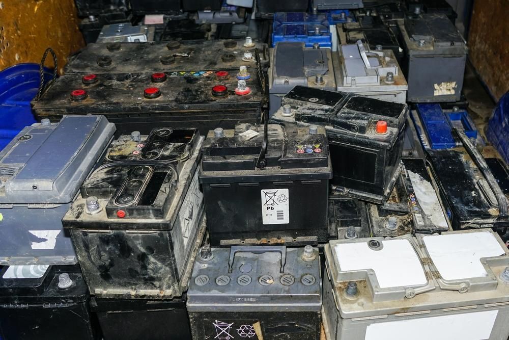 A Bunch of Old Batteries Are Stacked on Top of Each Other — Envy Automotive in Gorokan, NSW
