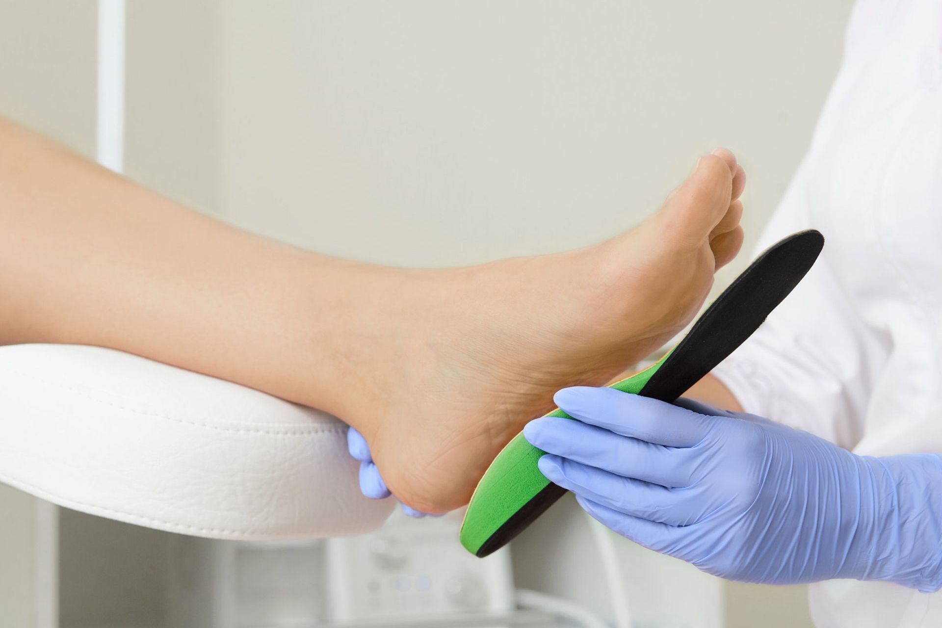 A close up of a person 's foot being examined by a doctor.