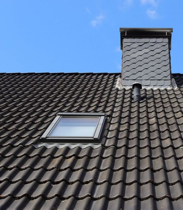 A roof with a skylight and a chimney on it