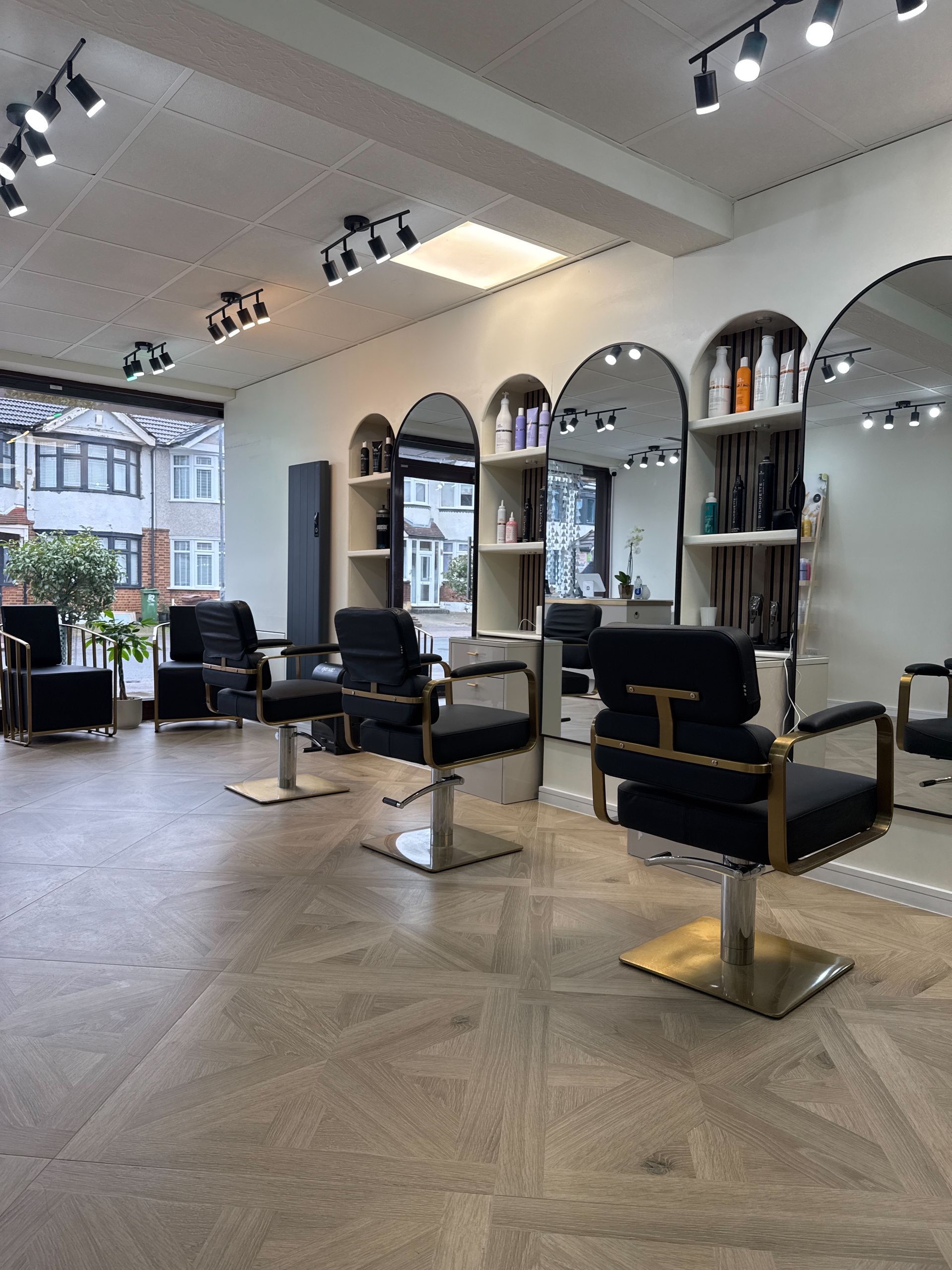 A hair salon with a lot of chairs and mirrors.
