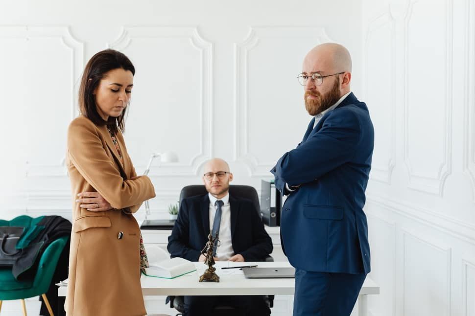 A man and a woman are standing next to each other in an office.