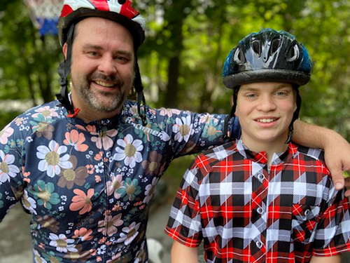 Disability Insurance: A man and a boy wearing helmets are posing for a picture.