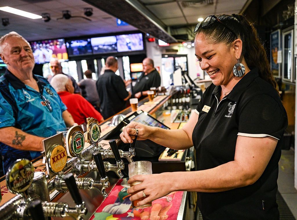 Woman at Beer Tap Pouring a Beer in Glass — Pub in Stuart Park, NT