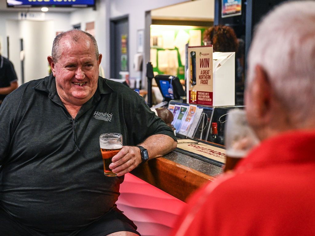 A Man Holding a Beer While Engaged in Conversation With Another Man — Pub in Stuart Park, NT 