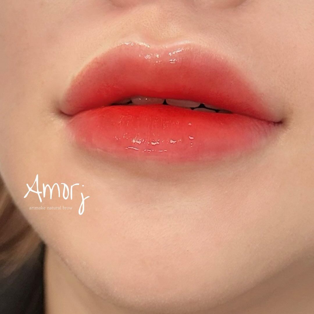 Close-up of lips with a red gradient lip tint and glossy finish.