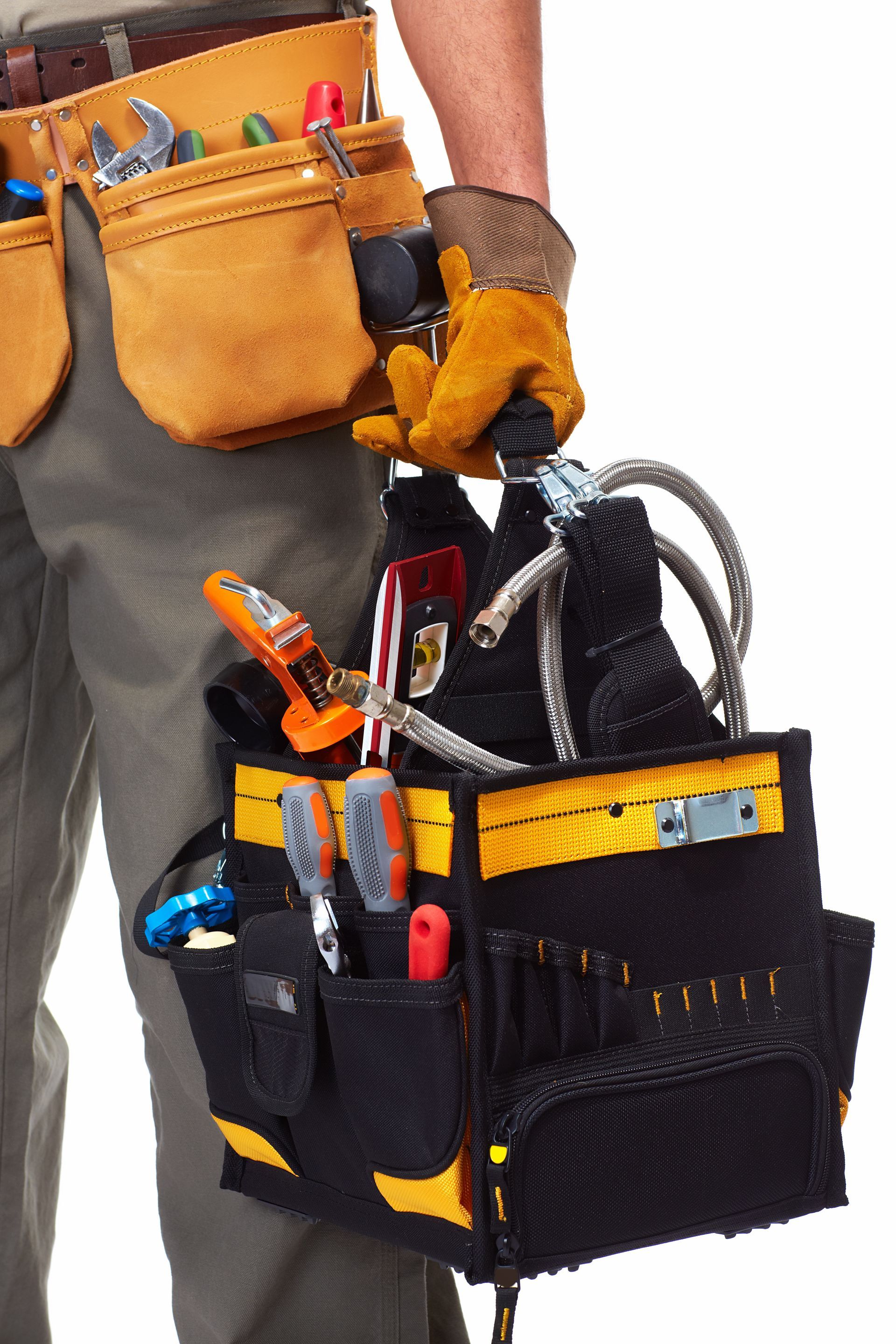 Tool belt and black utility pouch filled with tools hanging from a person’s waist