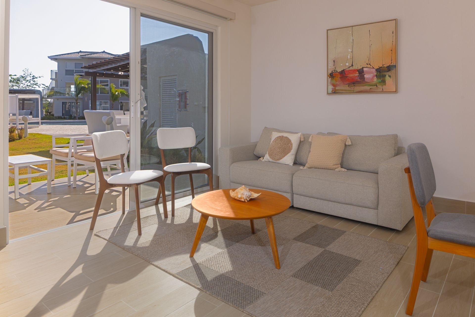 Modern living room interior with coastal decor and balcony access in Playa Caracol, Chame.
