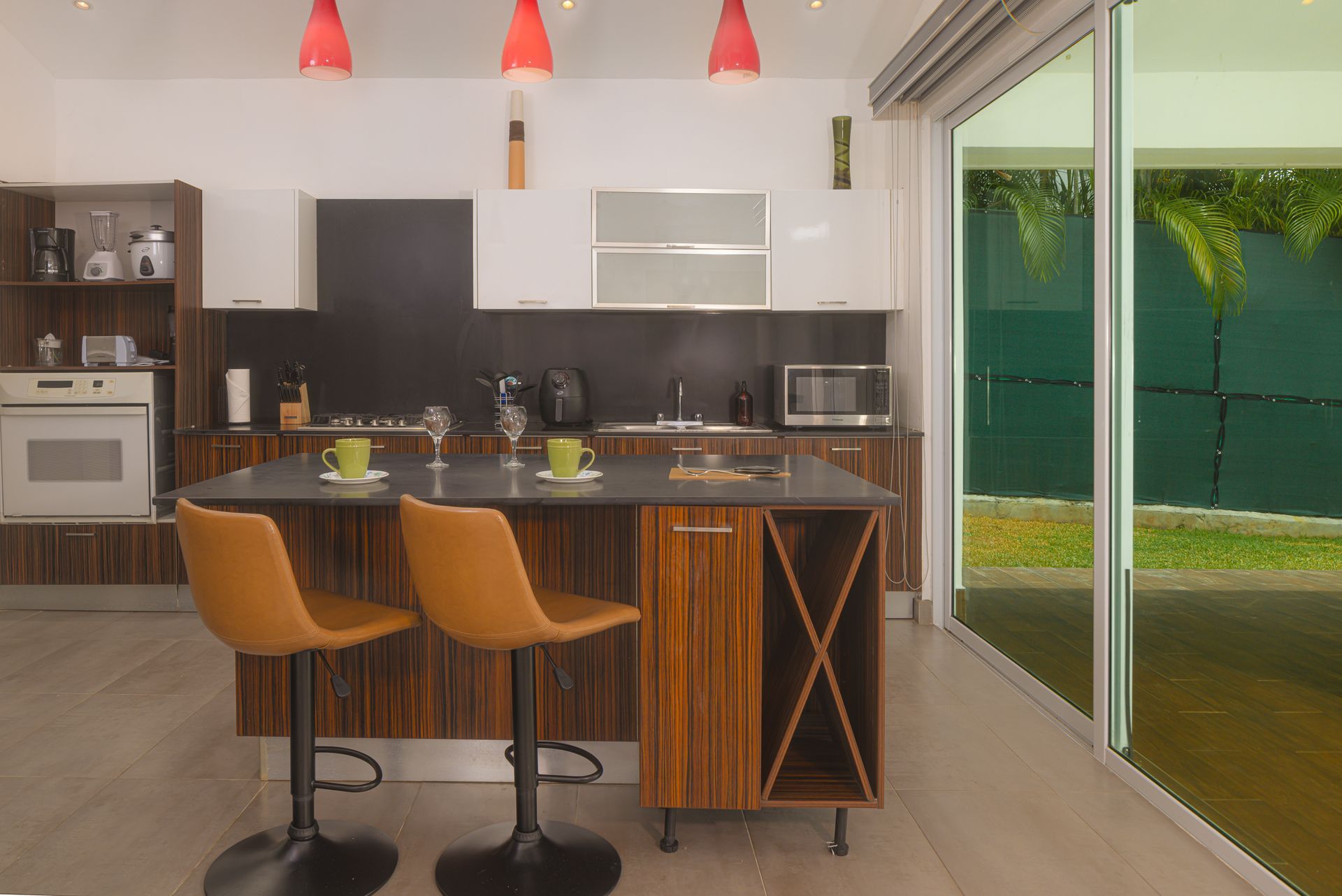 Modern luxury kitchen with wooden cabinetry and designer lighting in a private residence at Punta Barco.