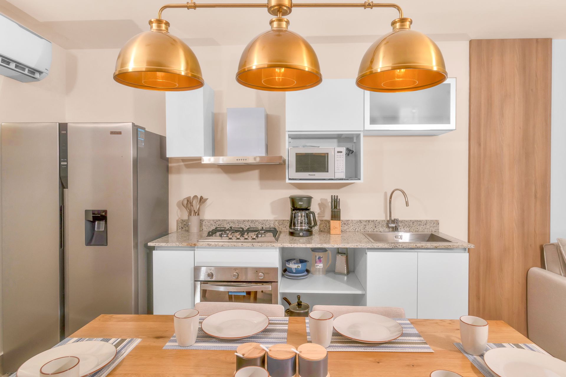 Open-concept kitchen and dining area with contemporary furniture in the Surfside building, Playa Caracol.