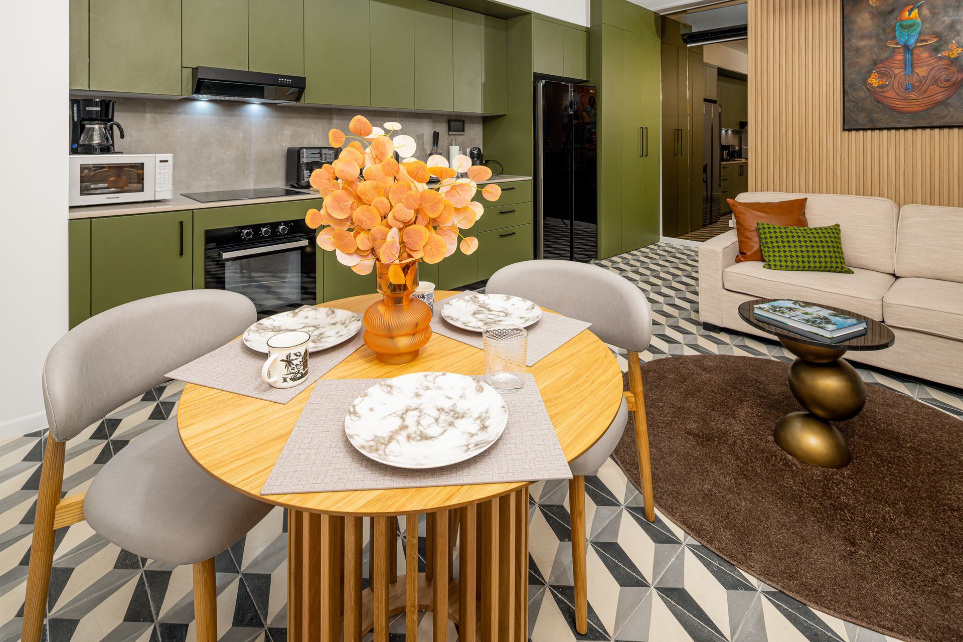 Modern olive green kitchen and dining area in a boutique Casco Viejo Airbnb.
