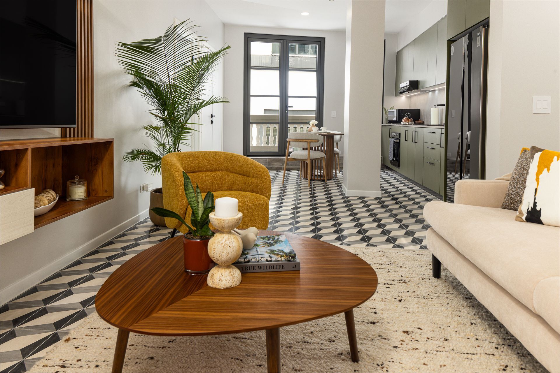 Modern Airbnb living room in Casco Viejo featuring historic hydraulic floor tiles and luxury furniture.