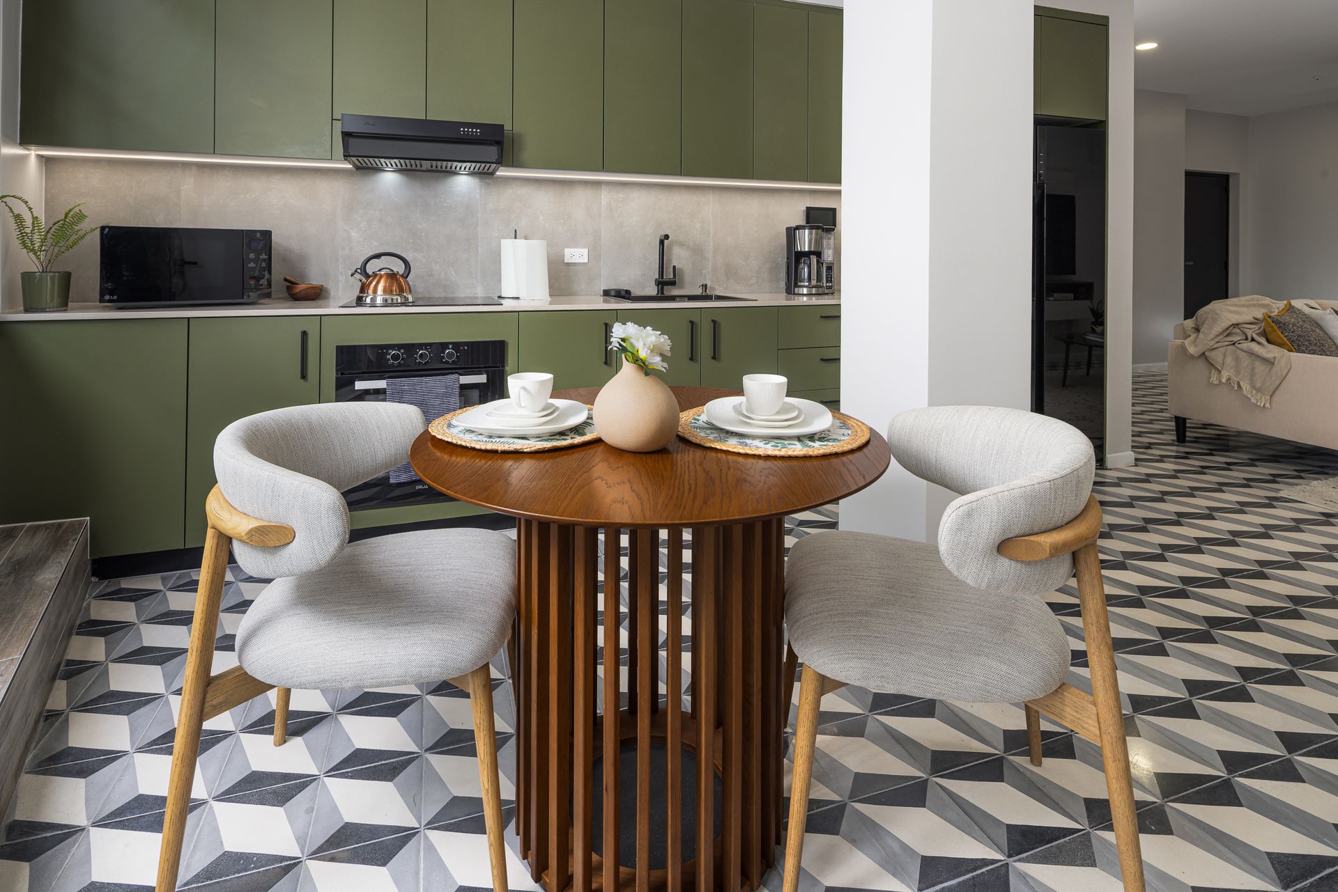 Modern olive green kitchen in a luxury Casco Viejo Airbnb apartment.