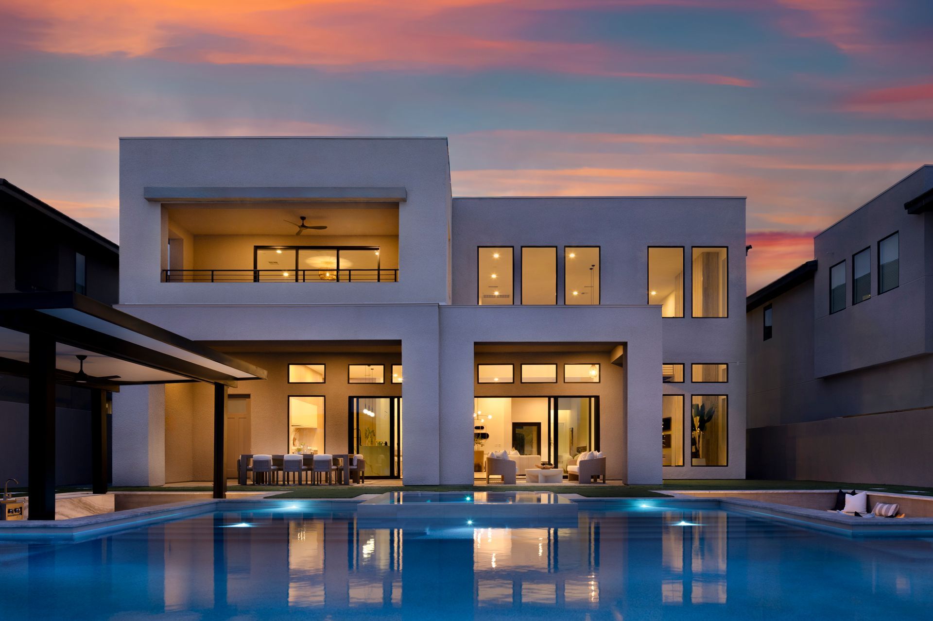 Luxury residential architecture in Las Vegas at sunset with pool and modern contemporary design.