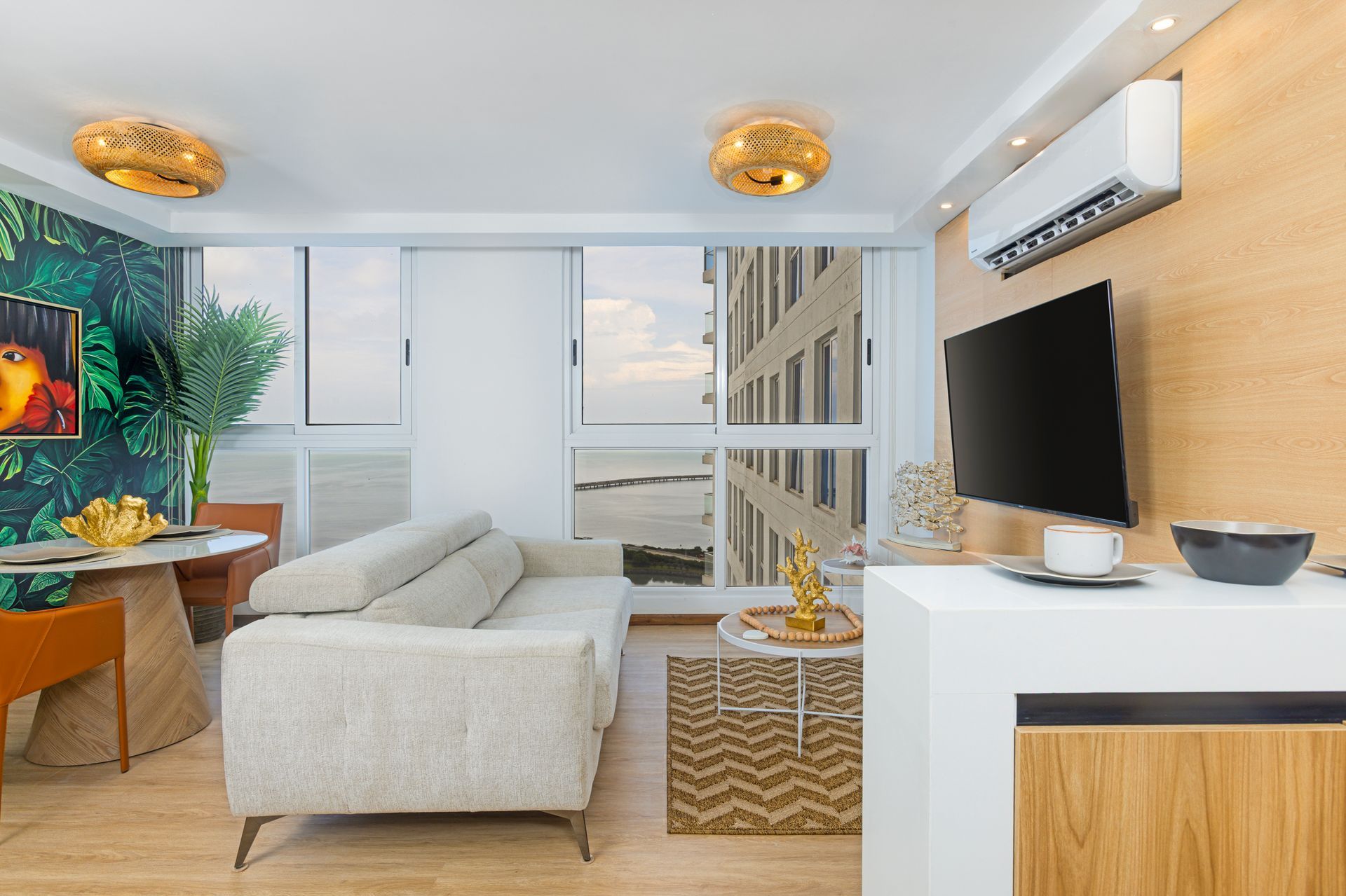 Open-concept Airbnb interior with designer furniture and natural light at The Sands building.