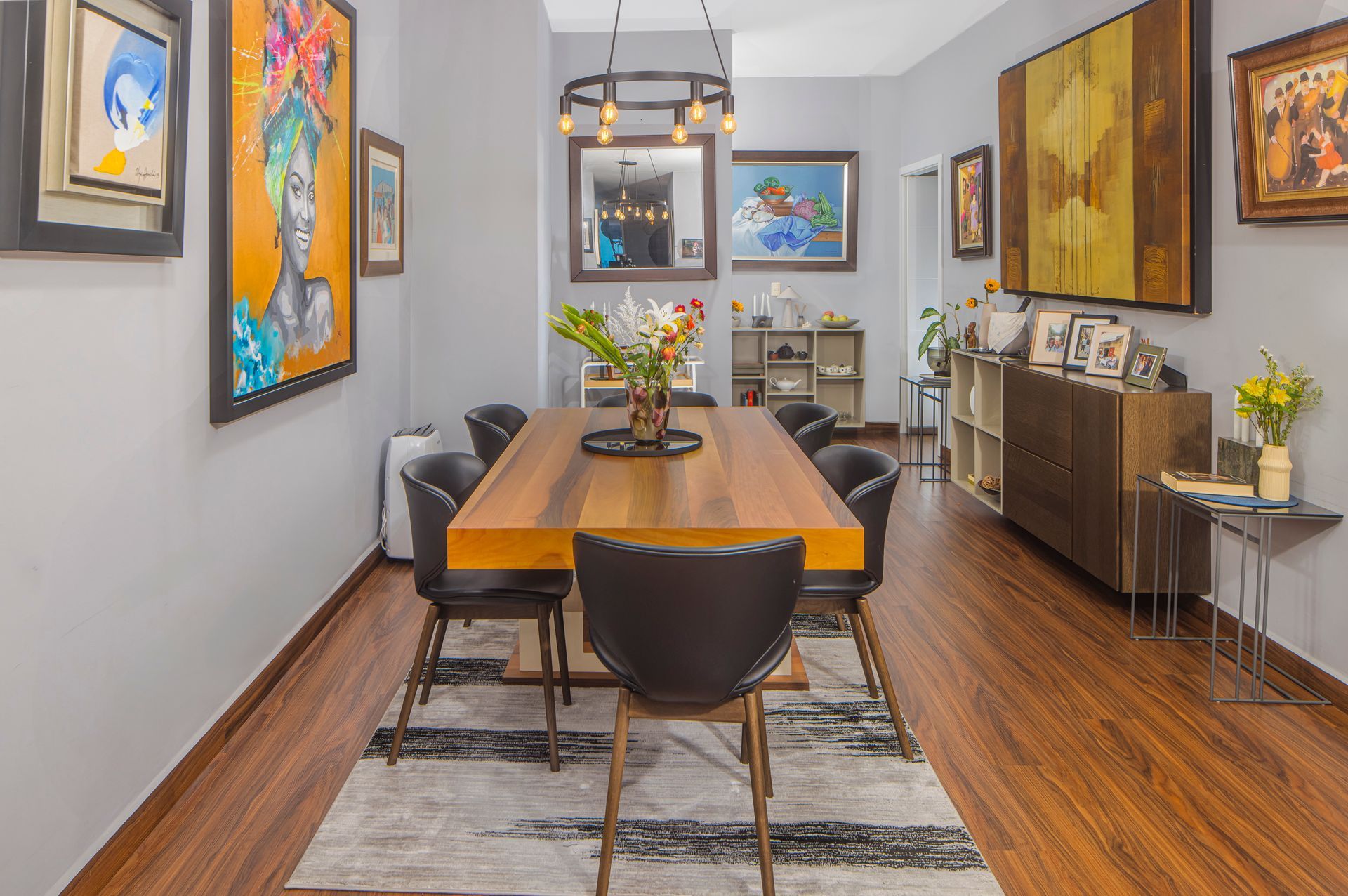 Modern dining room interior with wooden table and designer chairs in a luxury El Cangrejo apartment.