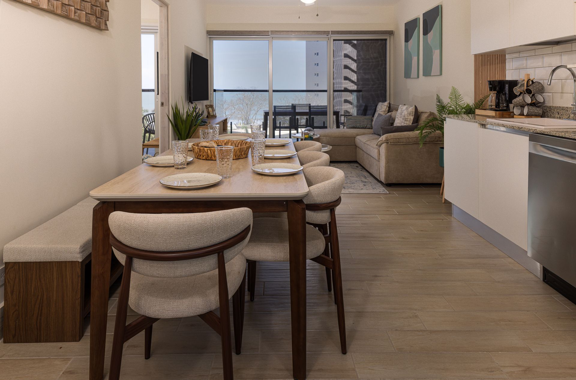 Dining area and living room of a Playa Caracol beachfront apartment with Pacific Ocean view, interior design by Furnishing Solutions Panama.