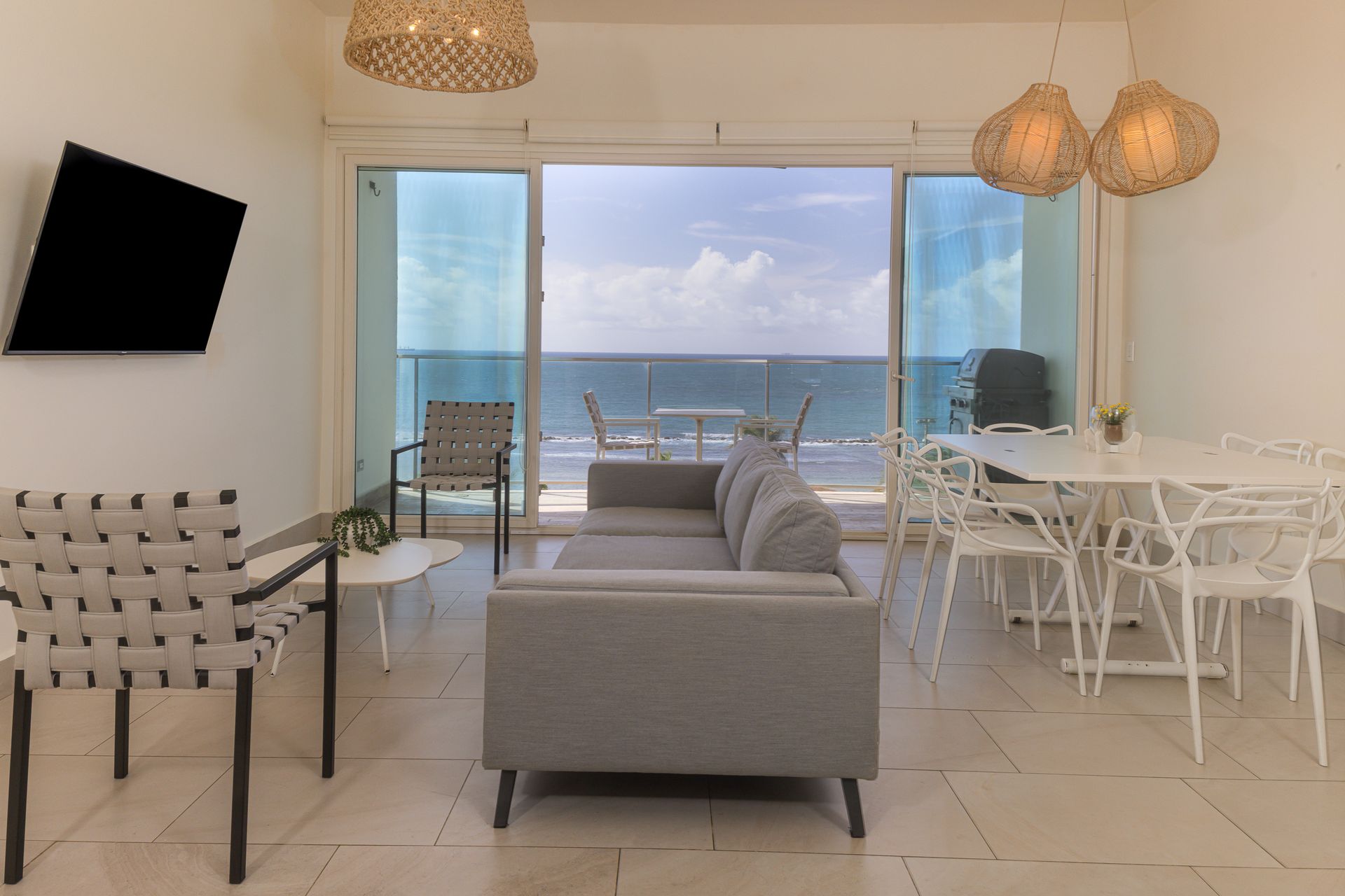 Open living area with panoramic Caribbean Sea view in Airbnb apartment at Playa Escondida Resort