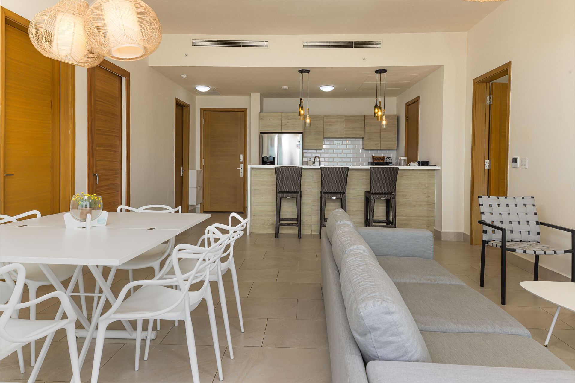 Open kitchen and dining area with breakfast bar and pendant lights in Playa Escondida Airbnb, Panama