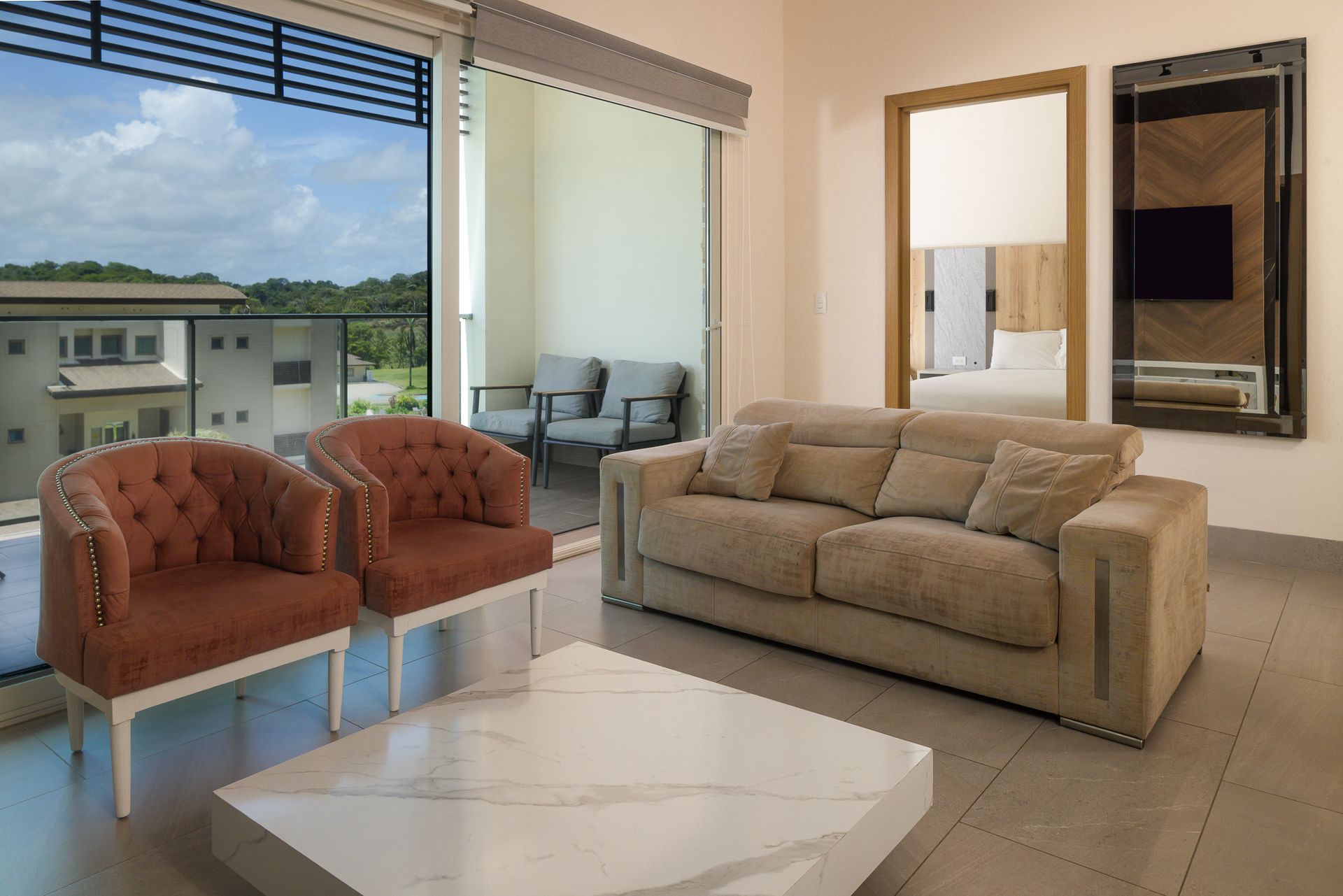 Caribbean Airbnb living area with beige sofa and balcony at Playa Escondida Resort, Panama