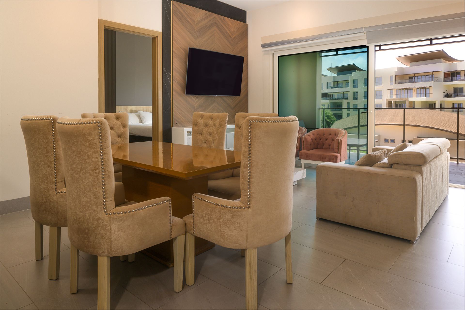 Designer dining area with tufted velvet chairs and herringbone wood panel at Playa Escondida Airbnb, Panama