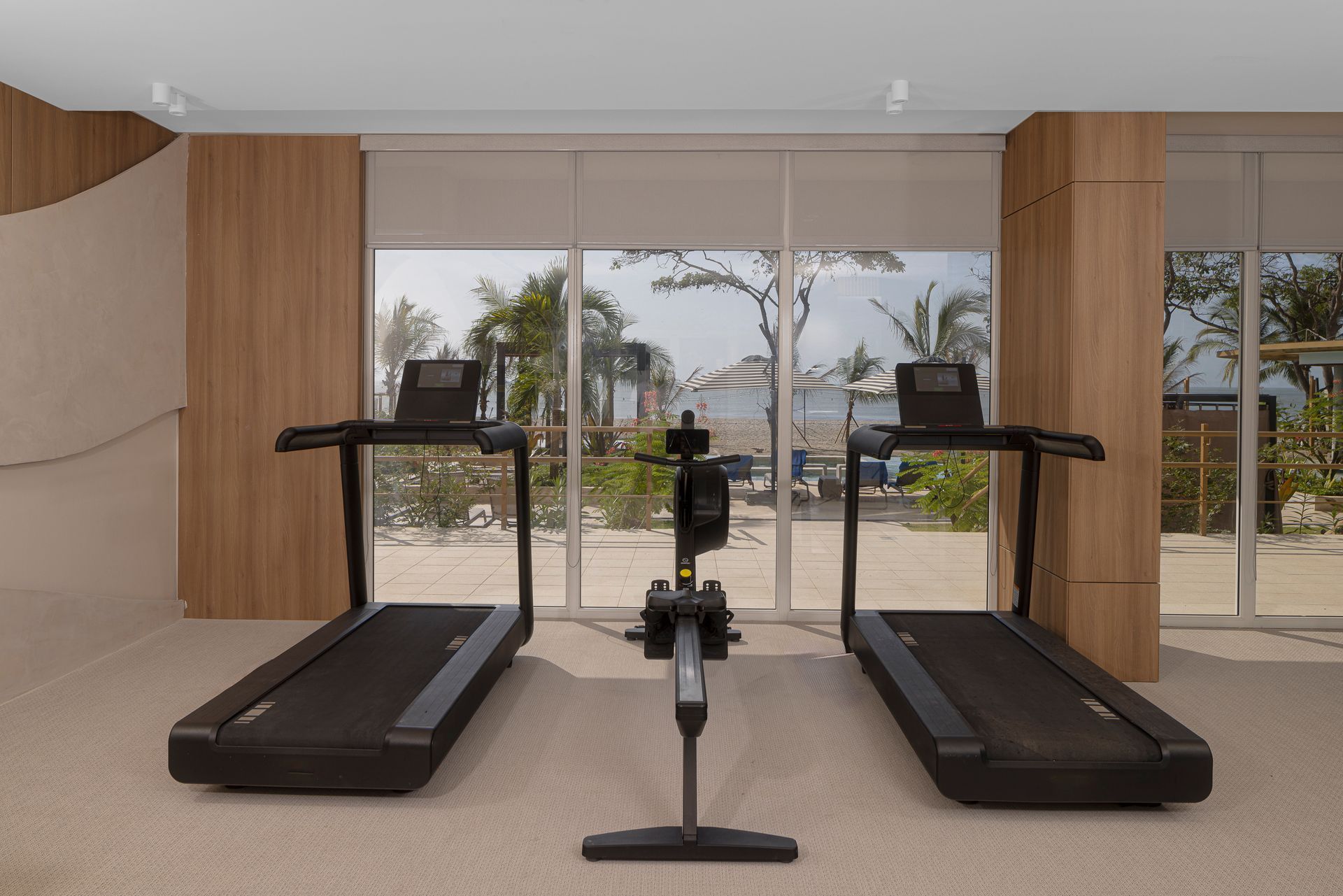 Modern gym with treadmills and ocean views at Radisson Riviera Pacifica hotel, Panama.