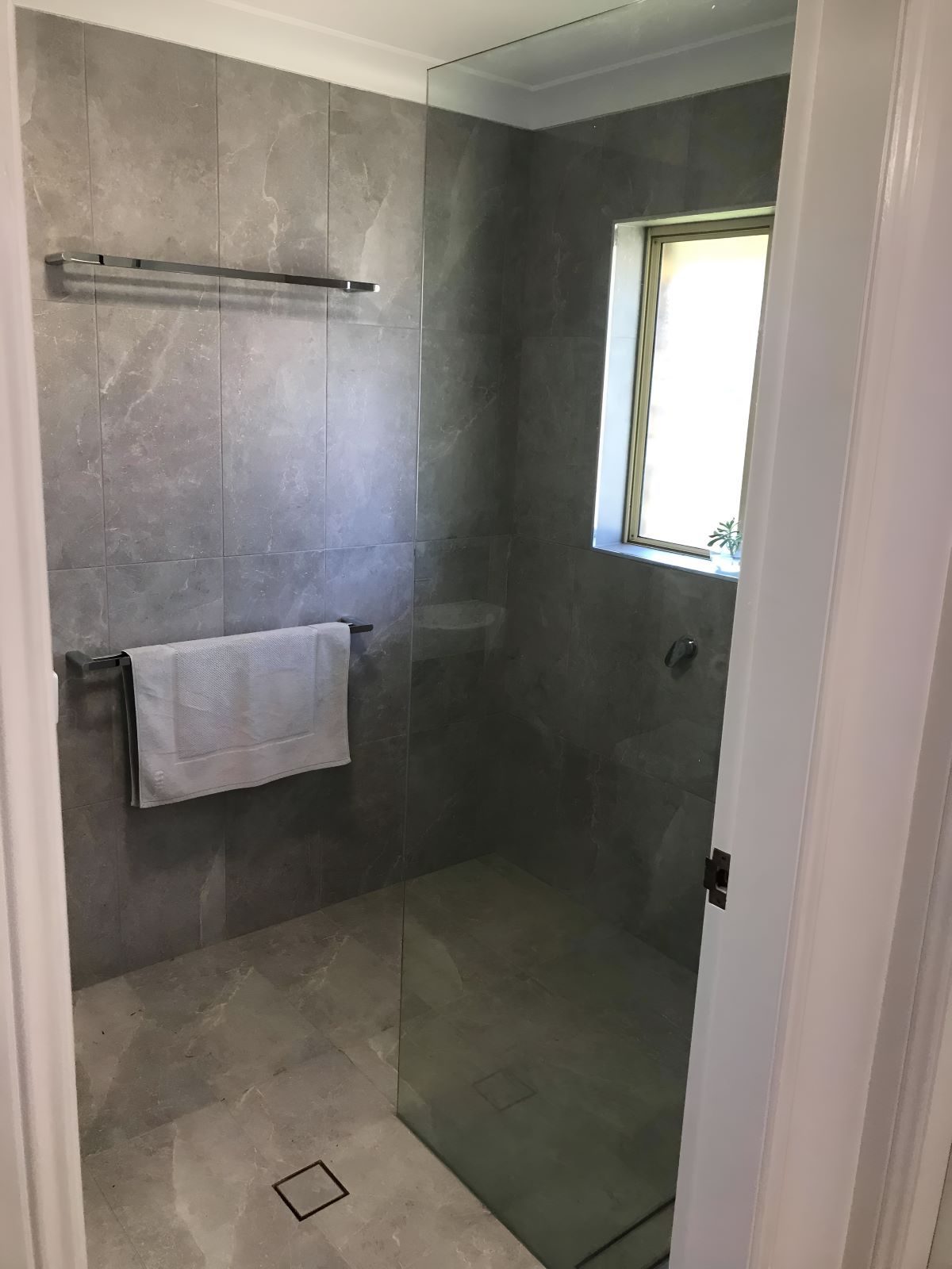 A Bathroom Featuring A Walk-in Shower And A Window — Coffs Coast Designer Bathrooms in Coffs Harbour, NSW