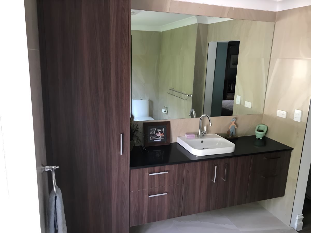 Bathroom With Large Mirror And Cabinet — Coffs Coast Designer Bathrooms in Toormina, NSW